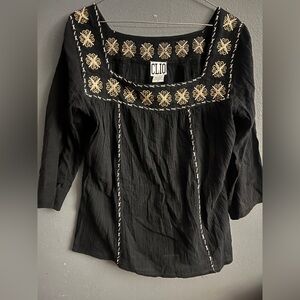 Clio black top with white and gold-toned floral embroidery